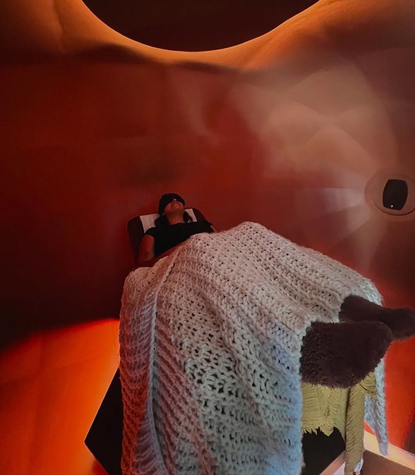 Guest reclining inside the Harmonic Egg chamber